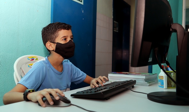 Imagem de um aluno na frente do computador