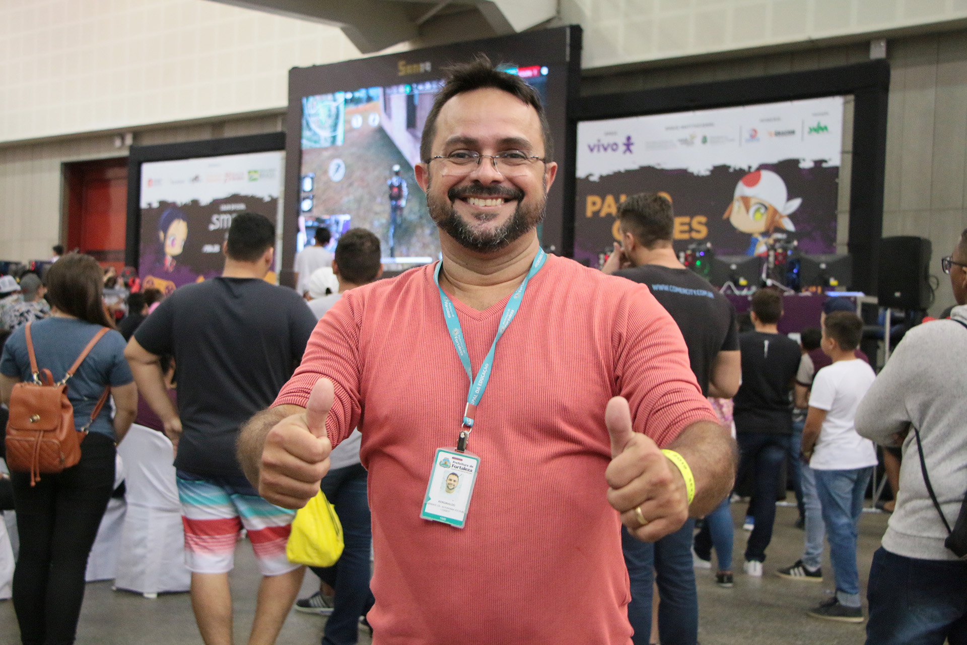 Homem de óculos sorrindo e fazendo gesto de positivo