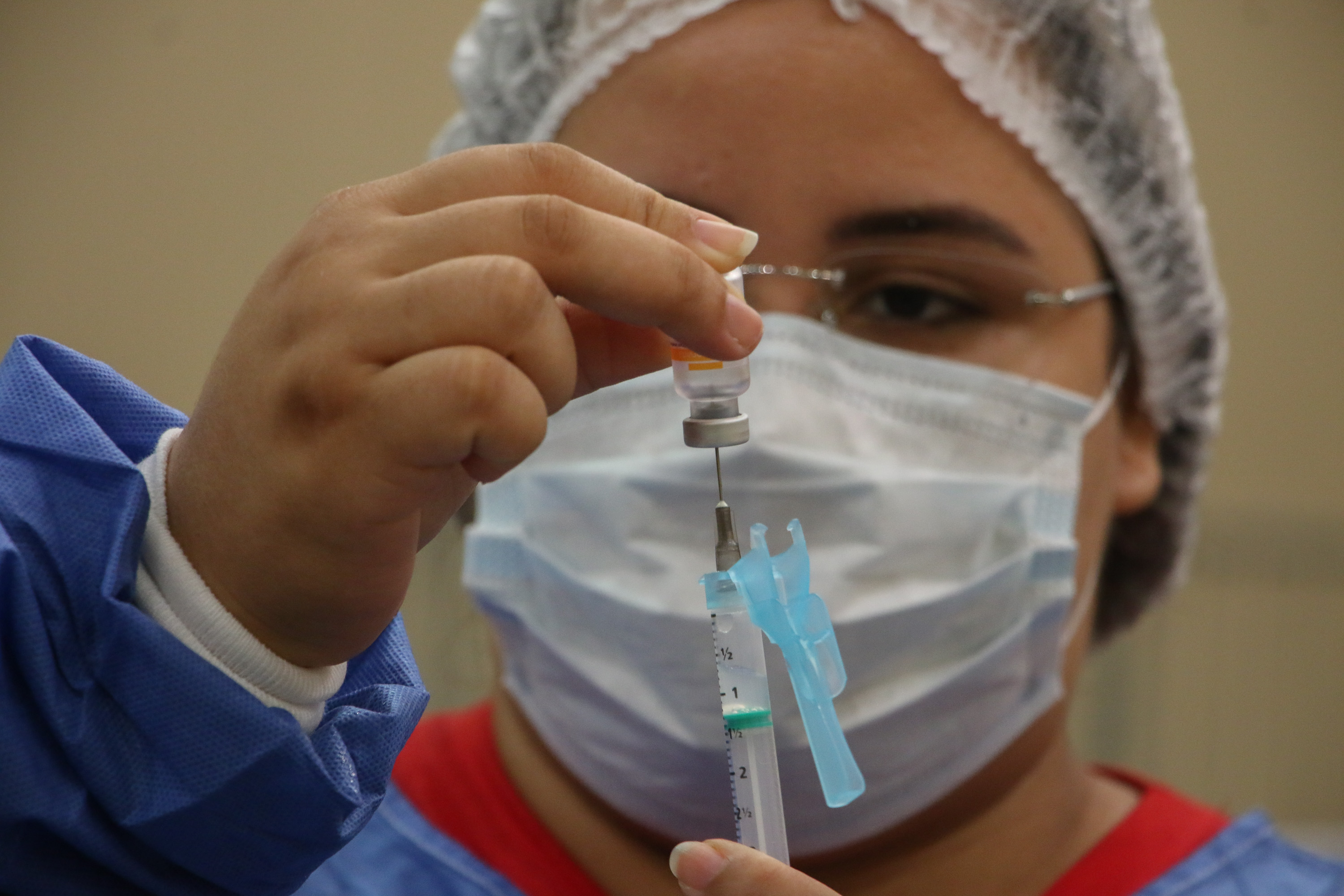 enfermeira ajusta uma seringa de vacinação