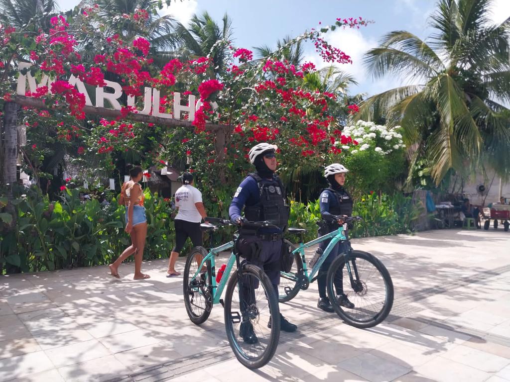 Guardas municipais posicionados ao lado de bicicletas 