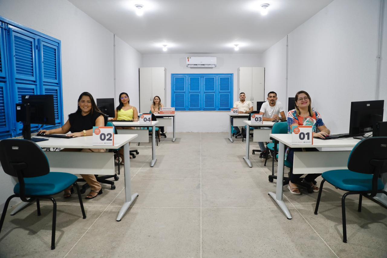 A foto mostra os funcionários do Cras Messejana sentados diante de suas mesas de trabalho, prontos para atender a população