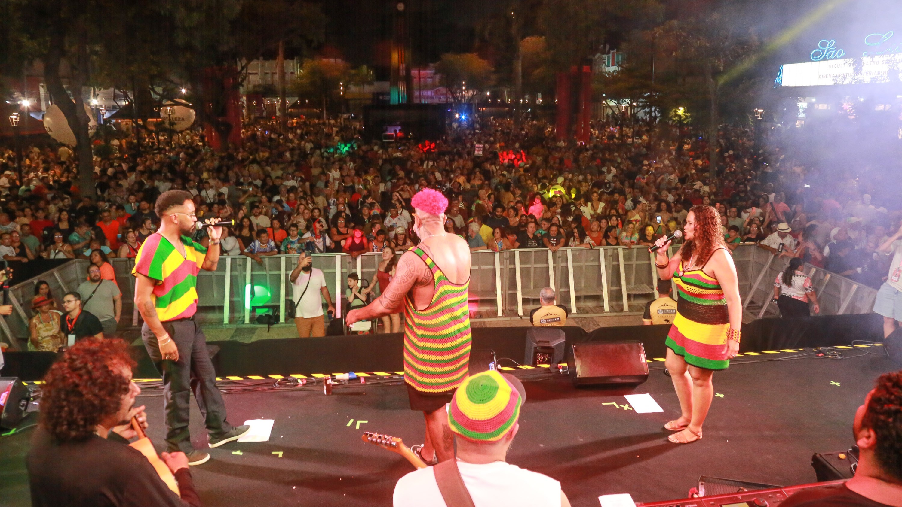 A imagem mostra a banda Mais Melanina se apresentando no Pré-Carnaval. Ao fundo é possível ver a Praça do Ferreira lotada